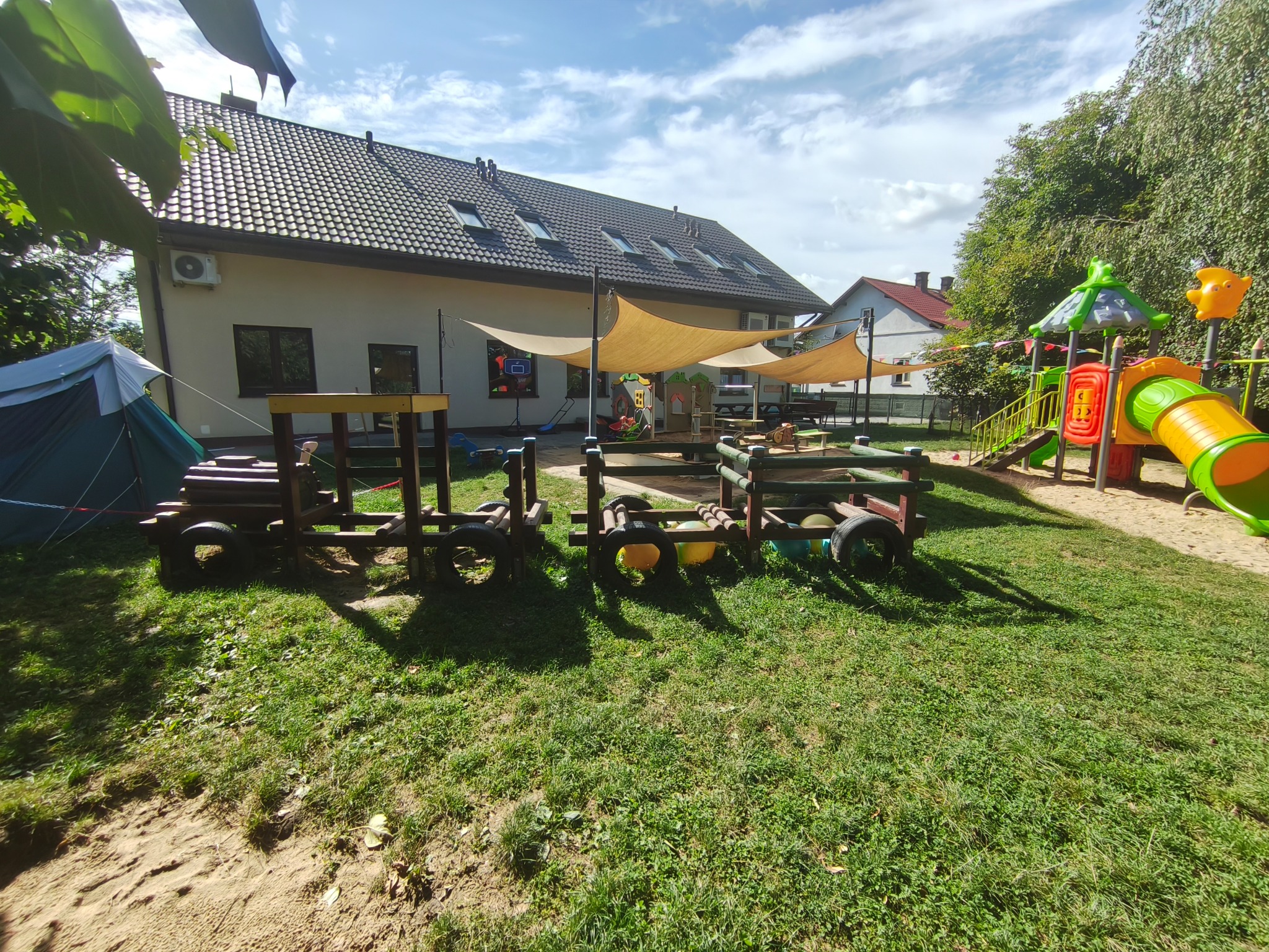 Aktualny widok ogrodu, drzew i zacienionej piaskownicy